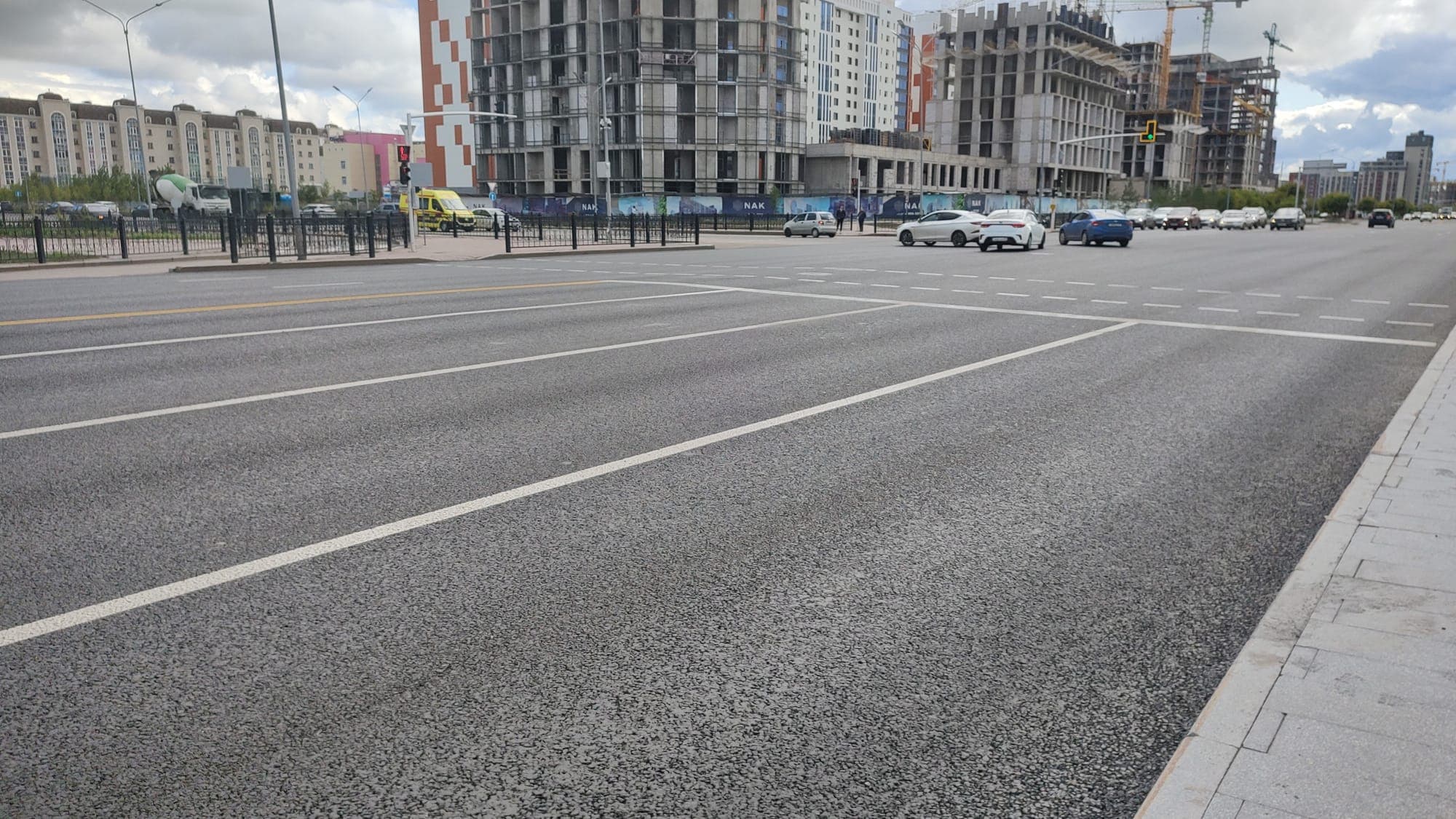 Applying road markings to the finished pavement of Mangilik El Avenue