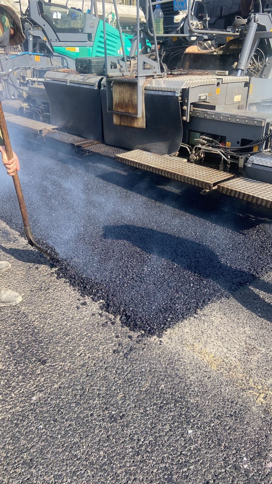 Paver feeding hot SMA-20 mixture on Turan Avenue