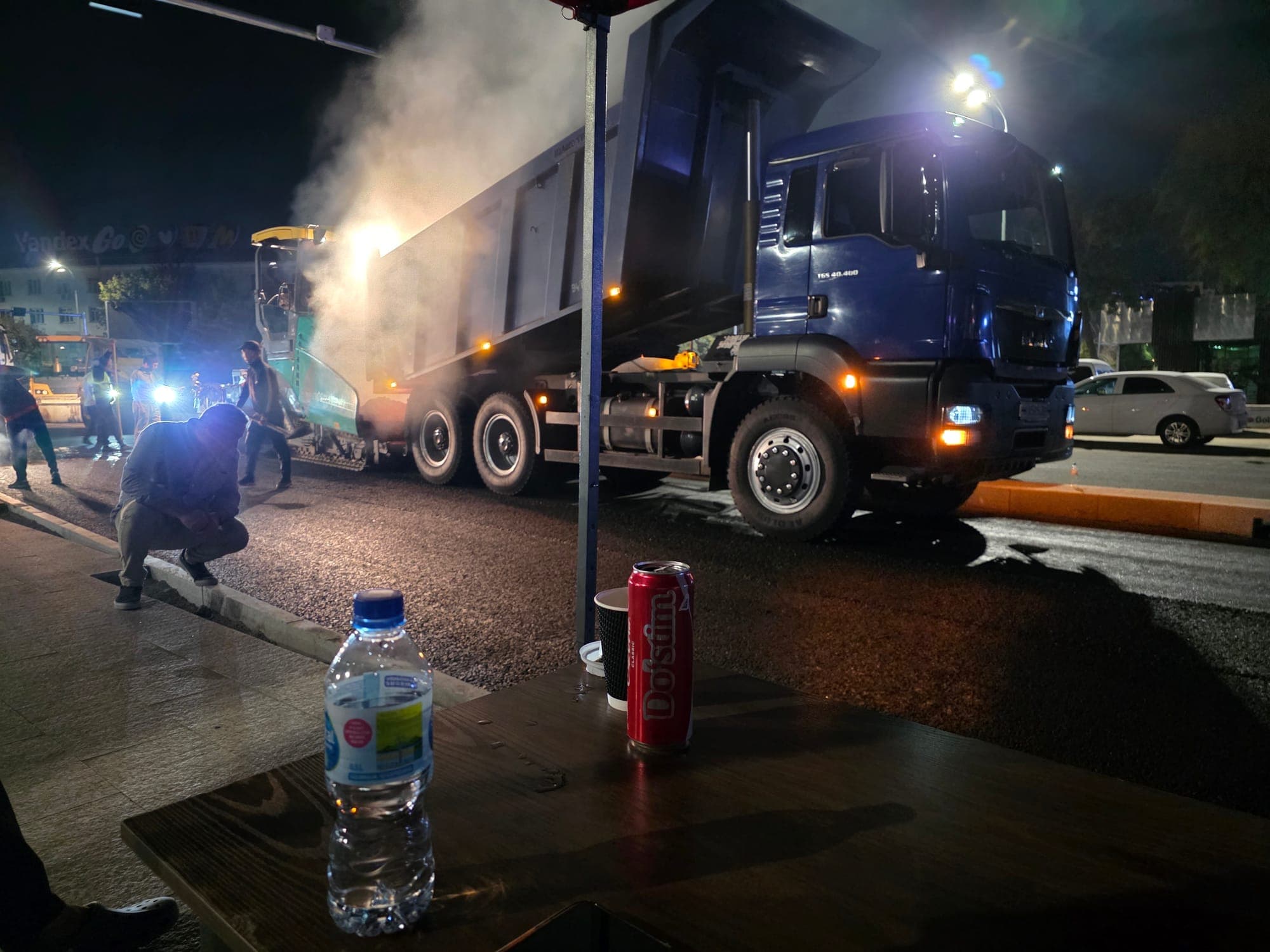 Paving SMA-20 at night, unloading the tipper